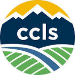 circle with golden yellow top, dark blue middle with jagged top, inside dark blue middle is white filled letter CCLS, green filled vertical stripes on bottom with one blue filled slanted line going through the green filled lines